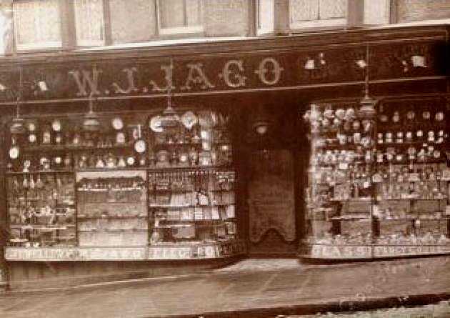 The original W.J. JAGO shopfront on St Albans High Street, photographed around 1900, with gilt sign-script and gas-lit display windows.